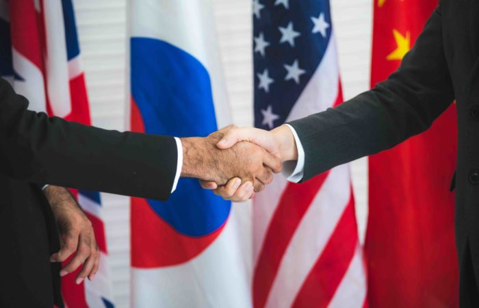businessmen closing an international trade treaty with a handshake